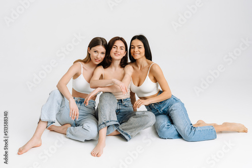 Three gorgeous brunette women posing at camera together