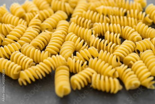 Uncooked eliche pasta isolated on dark background with clipping path