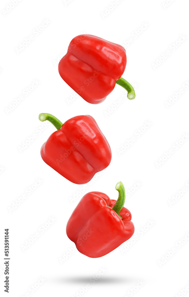 Red bell peppers falling in the air isolated on white background. Red bell peppers falling in the air isolated on white background.