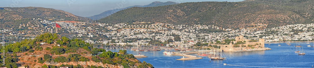 Panorama view of city and hills in romantic harbor of Bodrum in Turkey during the day. Scenic landscape view of sailing yachts in cruise port and bay. Tourism abroad, overseas in Aegean sea dockyard