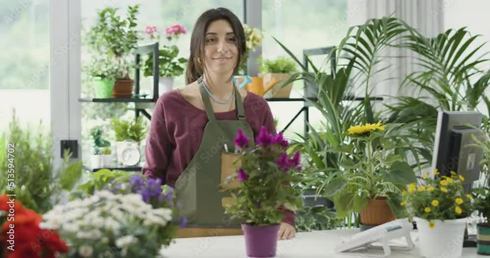 Young florist working in her plant shop Young florist working in her plant shop