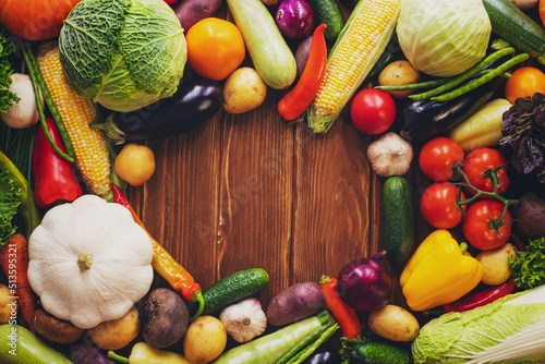 Healthy food background with copy space. Assortment of fresh vegetables on wooden background. Harvest of vegetables