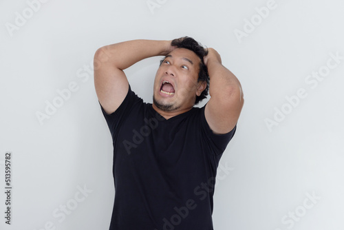 Asian Man Grabing His Hair While Screaming Out Loud