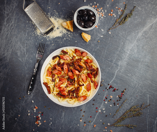 Dish of delicious cavatelli pasta with sausage, onion, parmesane and herbs. Top view