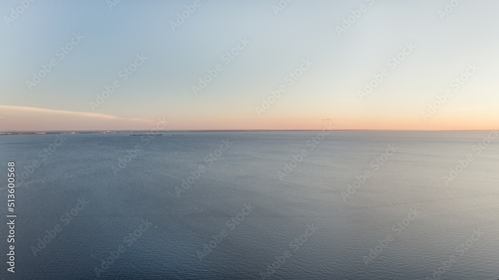 Calm blue sea and clear sky at sunset panoramic aerial view