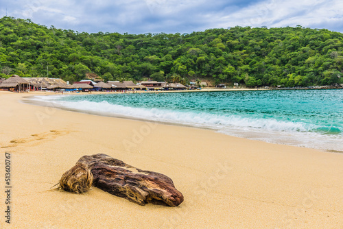 Huatulco bays -  Maguey beach. Beautiful beach with pristine waters, with turtles and fishes. Mexican beach with wooden huts by the sea photo