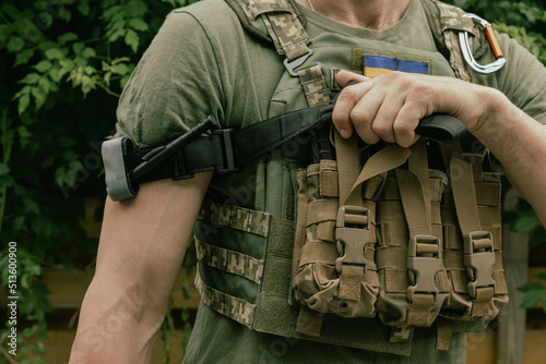 A military man holds a medical tourniquet in his hands to stop blood in first aid and prevent bleeding. Combat tactical equipment. Combat use Turnstile.