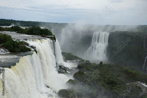The photo shows a stunning view from the top of the Iguazu Falls     a complex of 275 waterfalls on the Iguazu River  located on the border of Brazil and Argentina.
