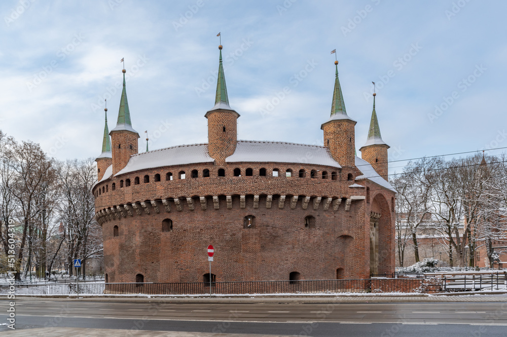 Fototapeta premium Medieval Barbicane, part of Krakow fortification, on snowy morning, Poland