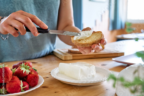 Photos Woman making summer strawberry sandwich