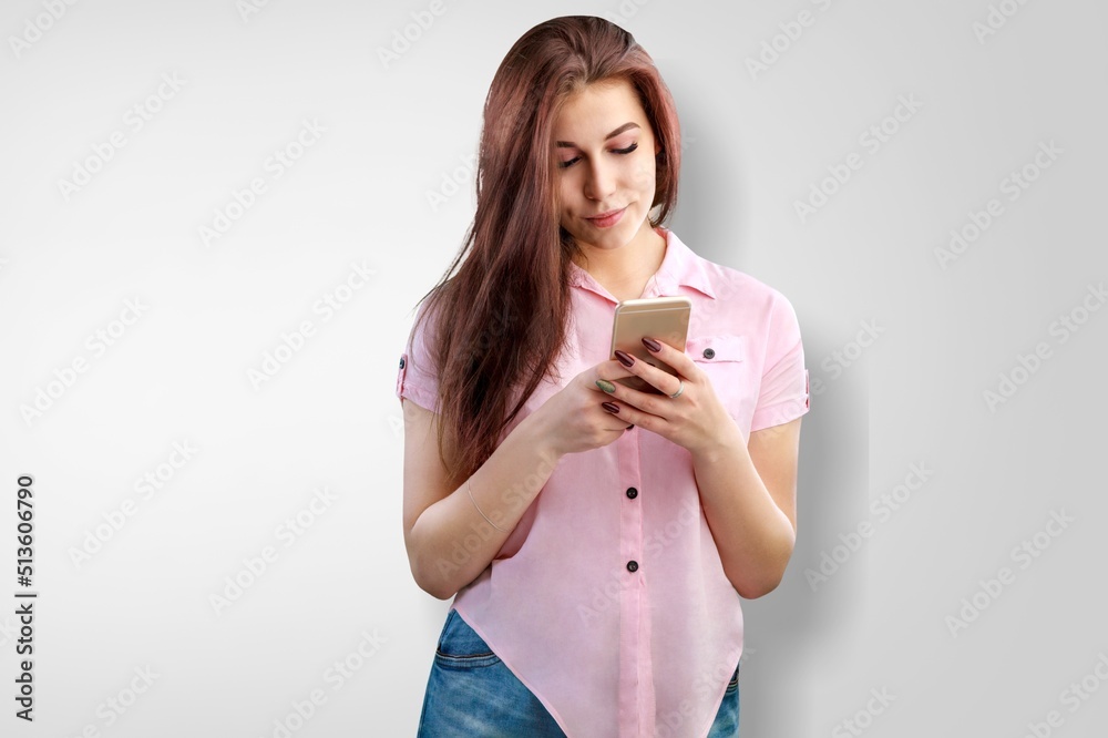 Portrait of smiling woman using mobile phone, chatting, texting message, standing Portrait of smiling woman using mobile phone, chatting, texting message, standing