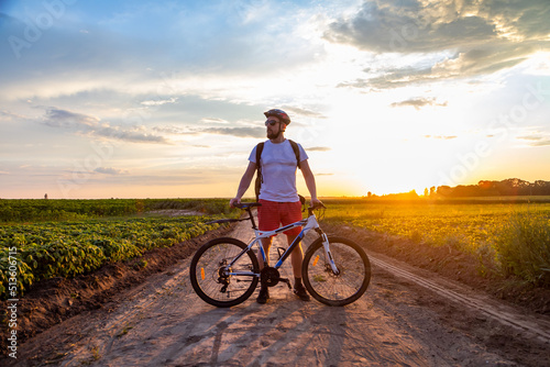 cyclist riding a bike at sunset, active lifestyle. The concept of extreme cycling, free space.