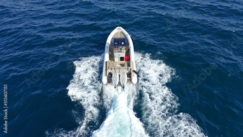Aerial drone photo of luxury rigid inflatable speed boat cruising in high speed in Aegean deep blue sea, Greece