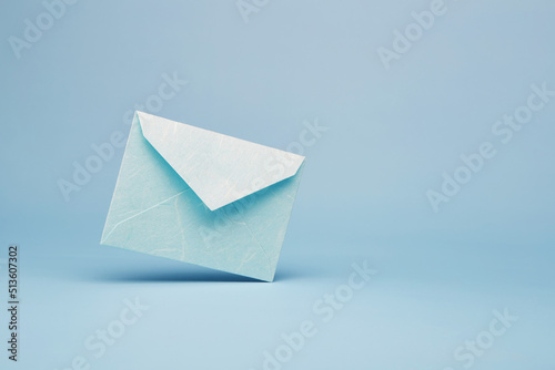 Bright blue color paper office envelope for greeting or invitation with copy space isolated on the bright solid fond plain blue background