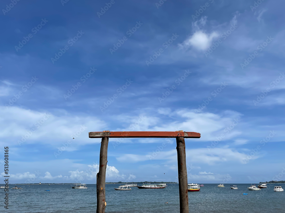 Senggigi Beach West Nusa Tenggara, Indonesia December 14, 2021: Square wooden door on the beach as a symbol of welcome by local residents to tourists who come to visit Senggigi Beach West Nusa Tenggara, Indonesia December 14, 2021: Square wooden door on the beach as a symbol of welcome by local residents to tourists who come to visit