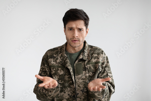 Depressed man soldier or veteran looking at camera and gesturing
