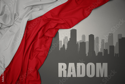 abstract silhouette of the city with text Radom near waving national flag of poland on a gray background.