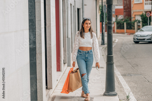 young latin girl in the street with shopping bags © carballo