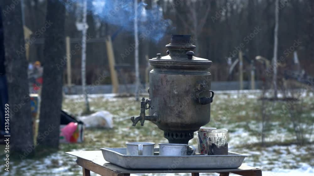 Old Russian wood-burning samovar with smoke. Old Russian wood-burning samovar with smoke.