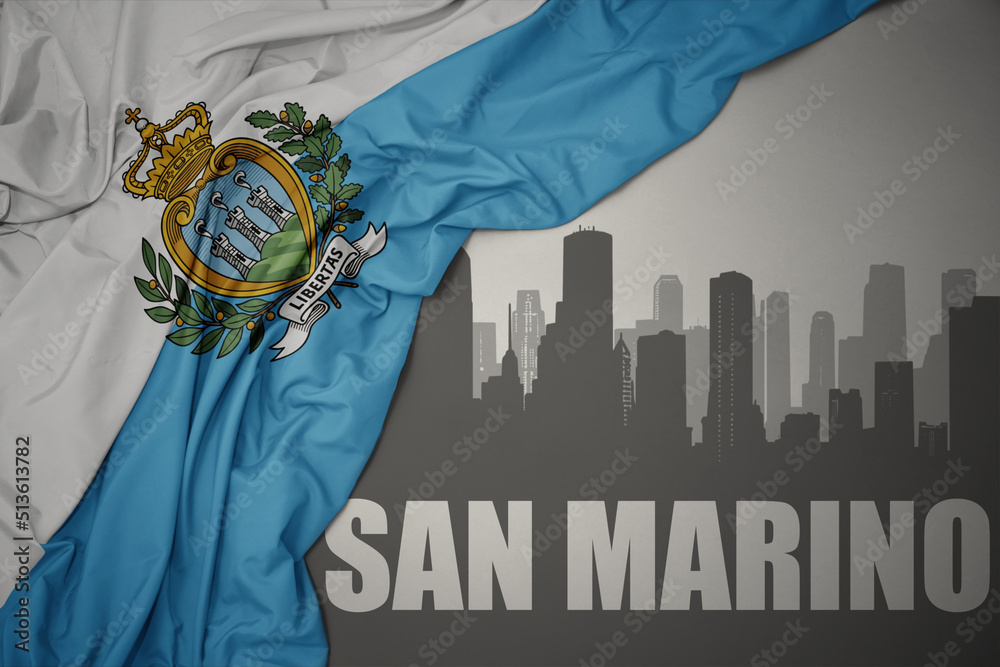 abstract silhouette of the city with text san marino near waving national flag of san marino on a gray background.