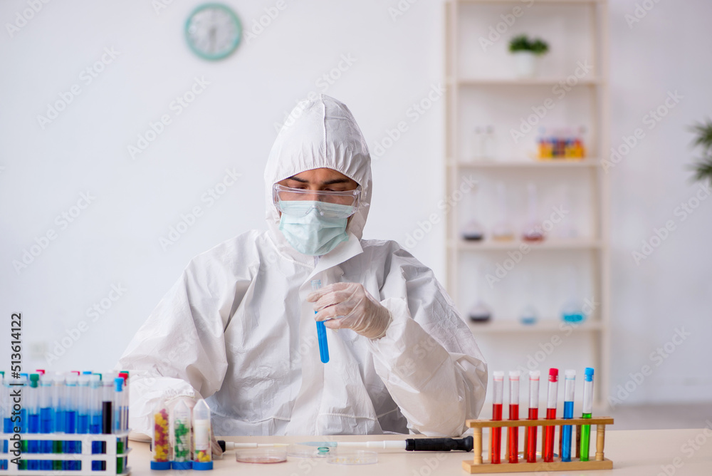 Young male chemist in drugs synthesis concept Young male chemist in drugs synthesis concept