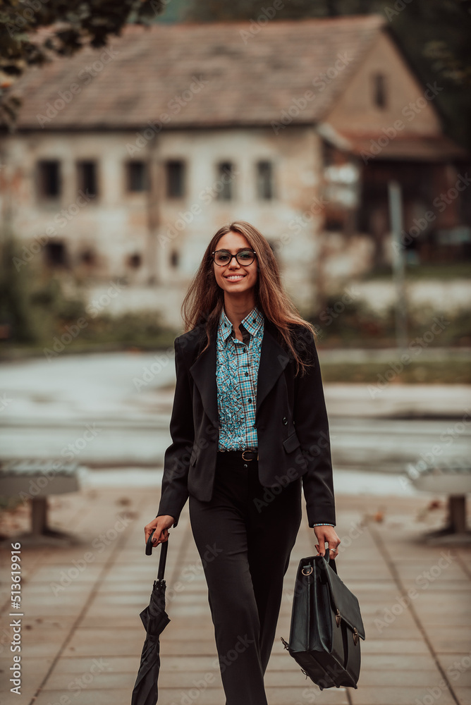 A business woman in a suit with a briefcase in her hand goes to work. Selective focus. Business concept. High quality photo