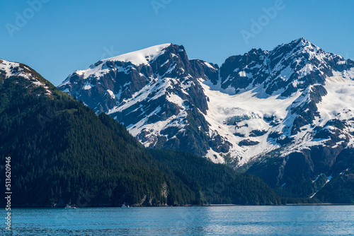 Fishing boats in the bay under snow covered peak of the mountain near the port of Seward in Alaska © steheap