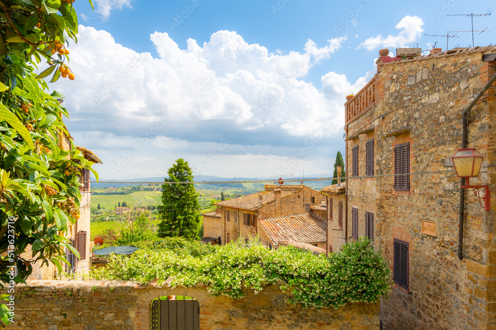 View of the hills and Tuscan countryside over the medieval hilltop village of San Gimignano, Italy.