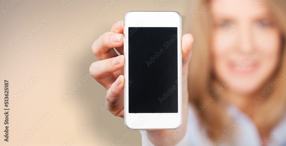 Stylish smiling woman showing smartphone blank screen, mobile app interface Stylish smiling woman showing smartphone blank screen, mobile app interface