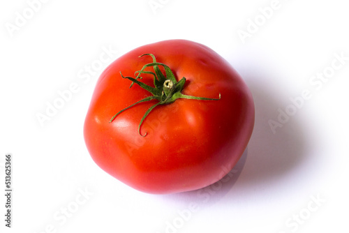 a red tomato lies on a white background