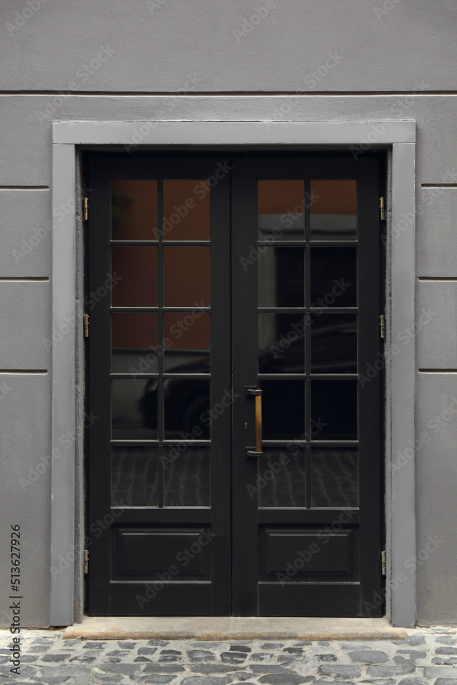 View of building with wooden door. Exterior design View of building with wooden door. Exterior design
