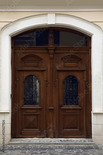 View of house with beautiful arched wooden door. Exterior design