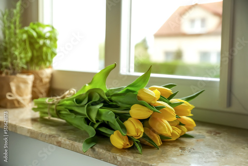 Bunch of beautiful yellow tulip flowers on windowsill #513628173