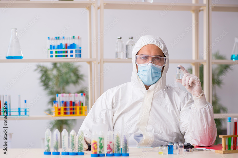 Young male chemist working at the lab during pandemic Young male chemist working at the lab during pandemic