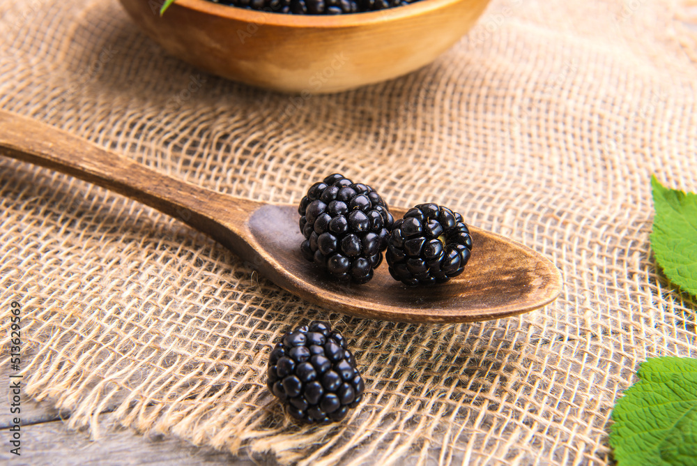 Close-up of blackberries on a wooden spoon. Selective focus. Close-up of blackberries on a wooden spoon. Selective focus.