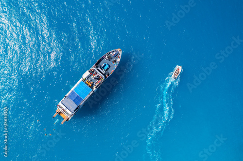 Aerial view of beautiful yacht and boat on the sea at sunset in summer. Lefkada island, Greece. Top view of luxury yachts,motorboat, clear blue water. Travel. Cruise vacation. Yachting. Seascape