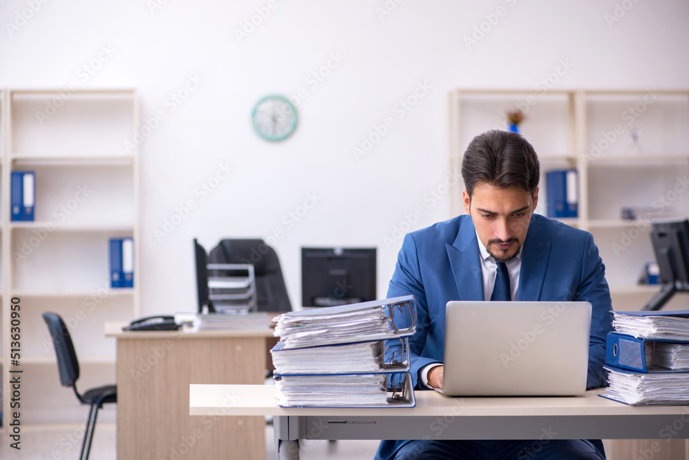 Young businessman employee unhappy with excessive work in the of Young businessman employee unhappy with excessive work in the of