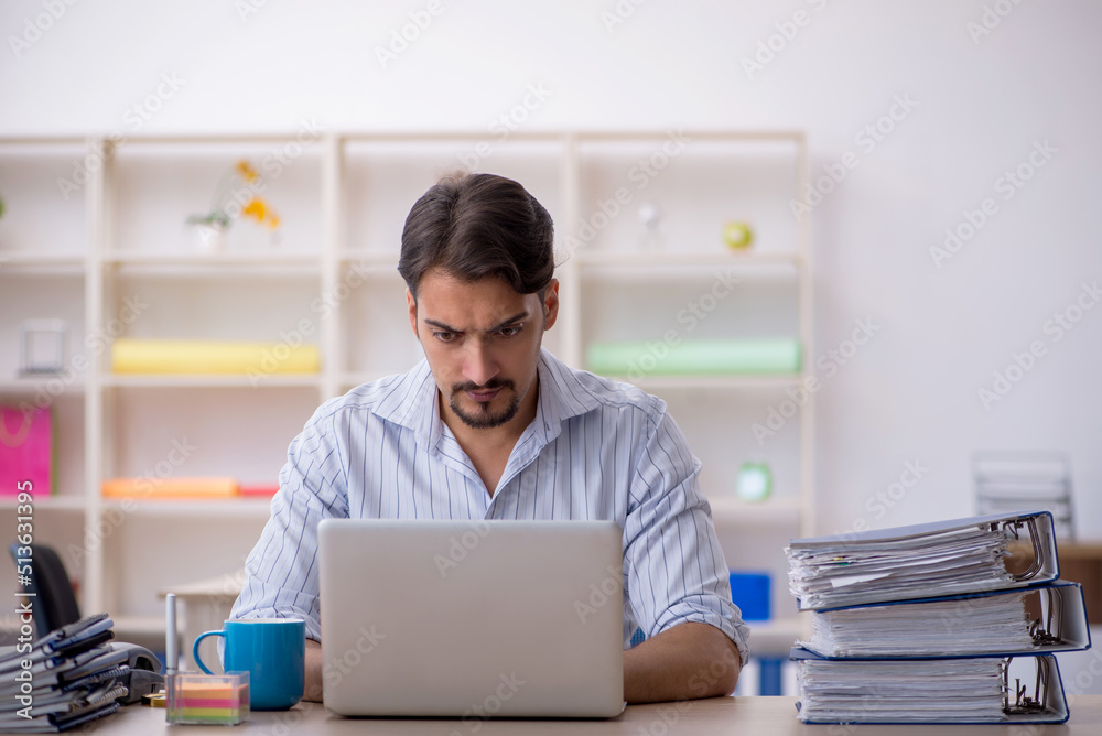 Young male employee working in the office Young male employee working in the office
