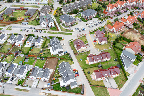 Aerial view of a densely built-up residential area with detached houses located in new private neighborhoods.