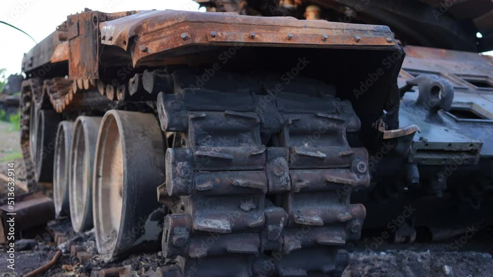 Close-up destroyed tank caterpillar outdoors in Kiev suburbs in Ukraine. Demolished military vehicle in war zone. Live camera moves left to right and right to left in slow motion Close-up destroyed tank caterpillar outdoors in Kiev suburbs in Ukraine. Demolished military vehicle in war zone. Live camera moves left to right and right to left in slow motion