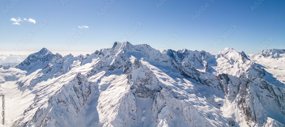 Amazing mountain range covered with snow against a blue sky 