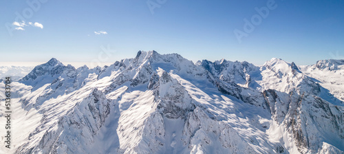 Amazing mountain range covered with snow against a blue sky 