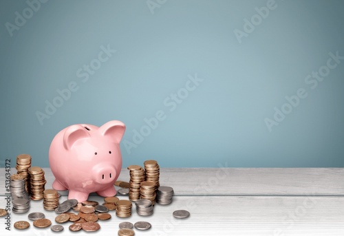 A pig saving. a pile of coins, business, investment, finance, and Money Saving for the future concepts.