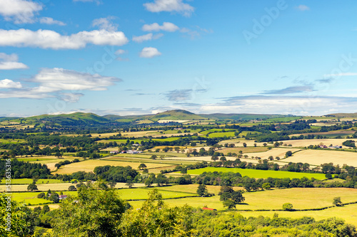 Obraz na płótnie Southwest from Wenlock Edge near Easthope over summer farmland of Ape Dale to Caer Cardoc and The Long Mynd, Shropshire, England w salonie