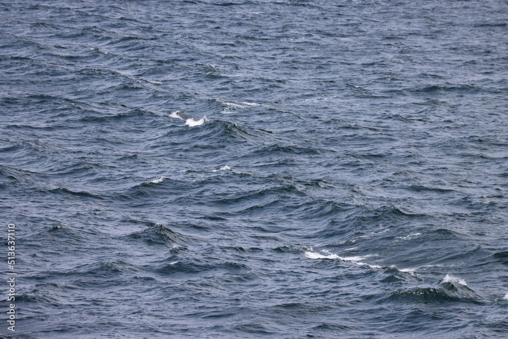 Waves far in open Baltic sea. Deep blue water, white foam on top of waves. Photo taken from ship Waves far in open Baltic sea. Deep blue water, white foam on top of waves. Photo taken from ship