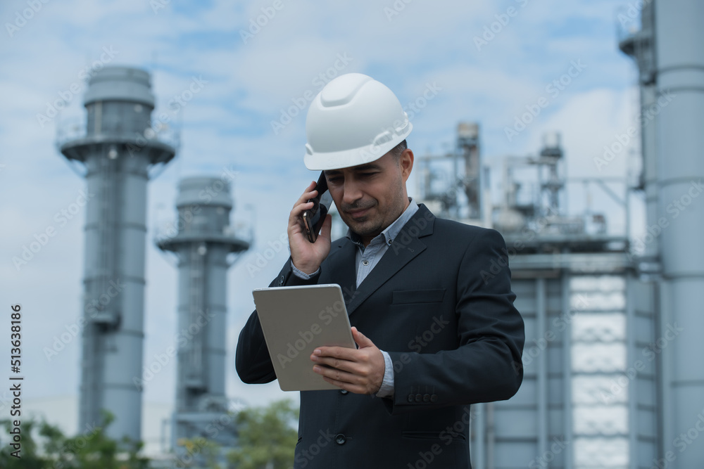 architect talking on phone on power plant bacground. architect talking on phone on power plant bacground.