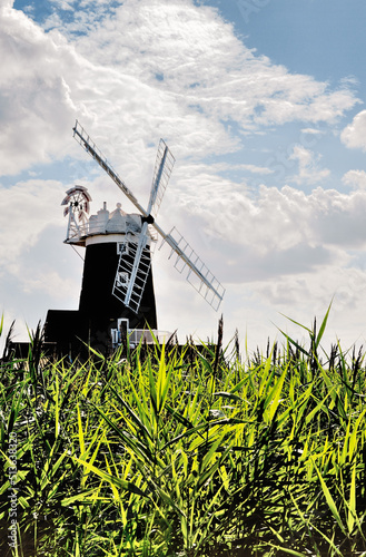 Over reed beds to 18th C Cley Windmill aka Cley Towermill in North Norfolk Heritage Coast village of Cley next the Sea, England photo