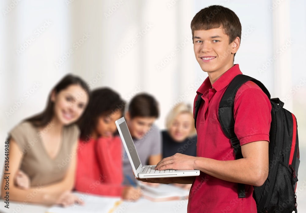 Smiling teacher during computer class at high school and looking at camera. Smiling teacher during computer class at high school and looking at camera.