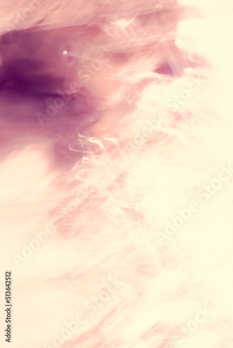 An image of smoke floating on an abstract surface in purple-yellow tones.