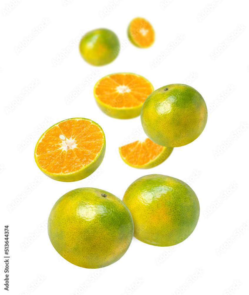 Tangerine orange fruit with cut half slice falling in the air isolated on white background. Tangerine orange fruit with cut half slice falling in the air isolated on white background.
